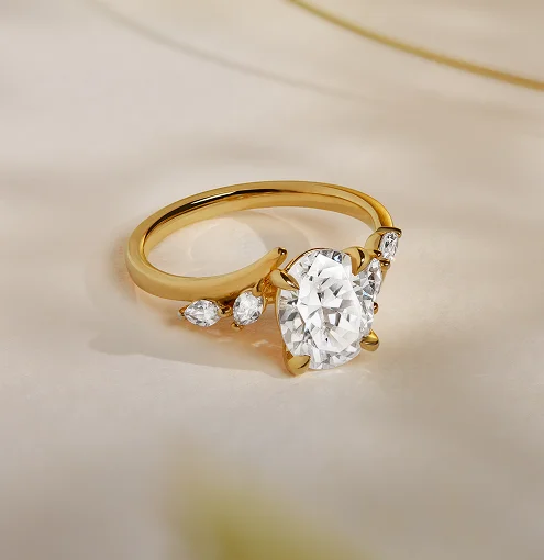 Woman wearing a variety of diamond and gemstone rings, bracelet, and necklace from Austen & Blake diamond jewelry collection